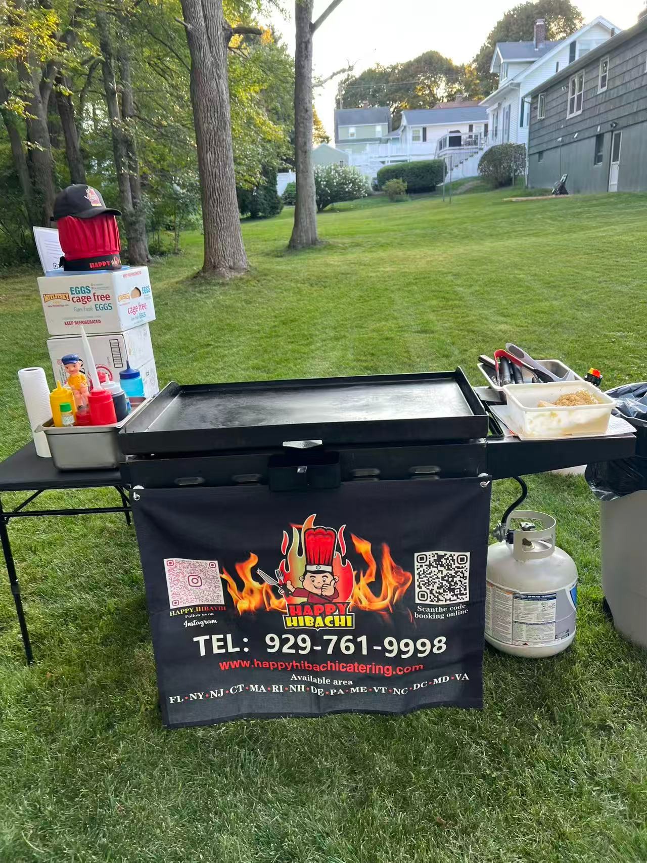 Professional hibachi chef performing at a Maine home event with flaming grill
